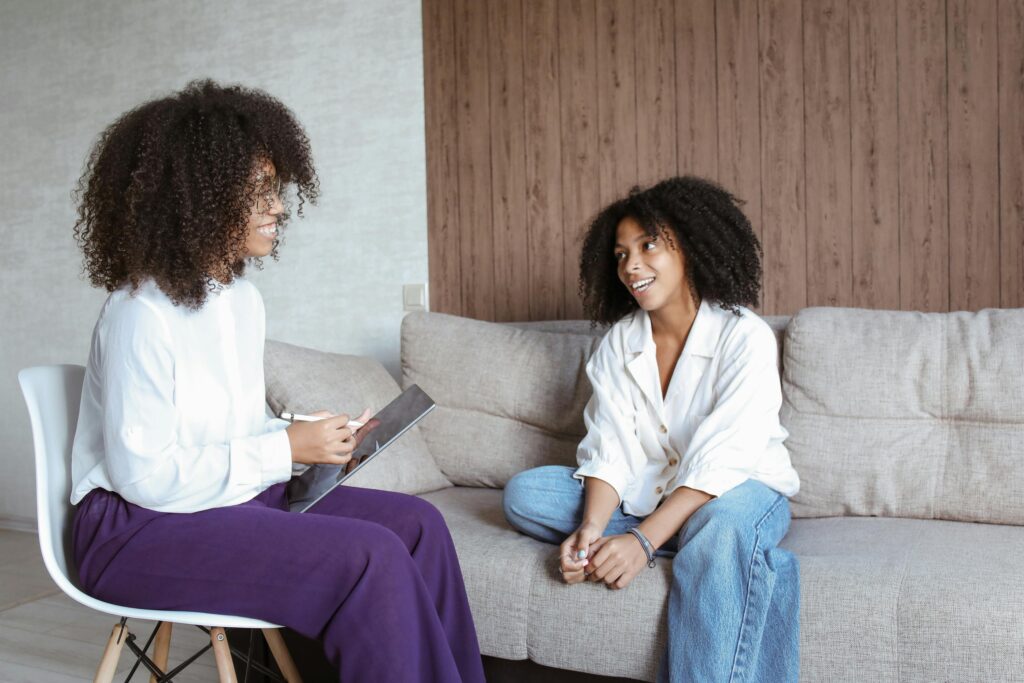 2 African American women discussing. Breaking barriers of mental stigma